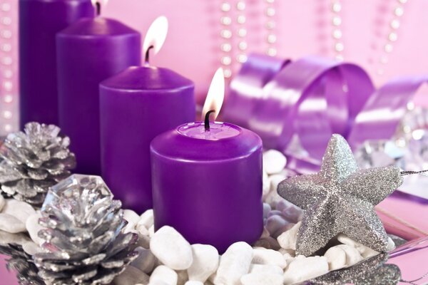 Purple candles in a circle of silver jewelry