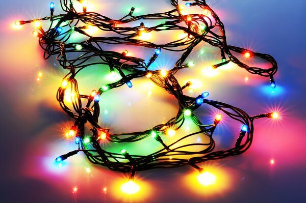 A multicolored garland sparkles on the floor