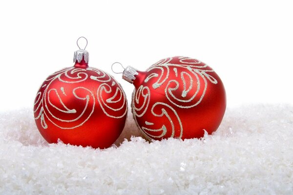 Two red Christmas balls in the snow