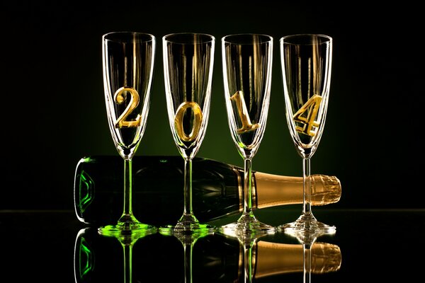 A bottle of champagne and wine glasses for the new year