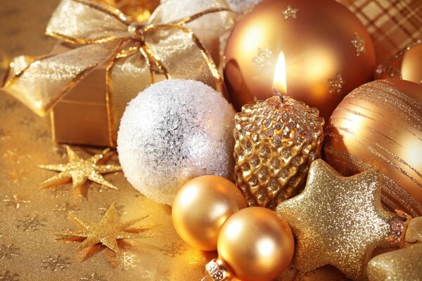 Christmas gold ornaments. Balls, stars and a candle