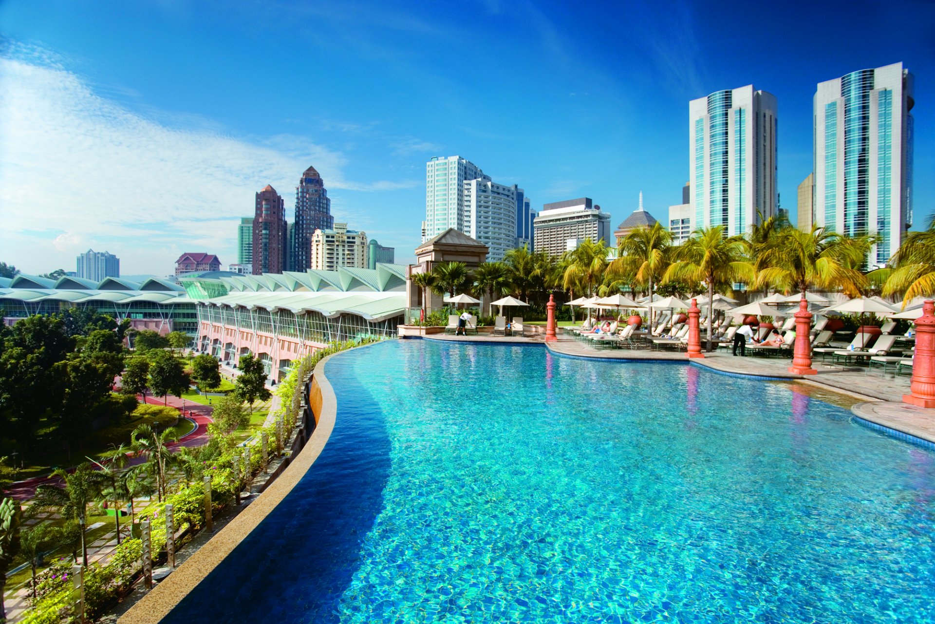 city kuala lumpur swimming pool palm trees buildings sky cloud