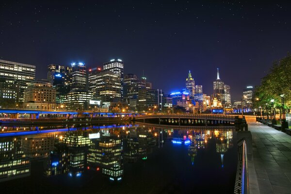 A bright photo of Melbourne shining with lights at night