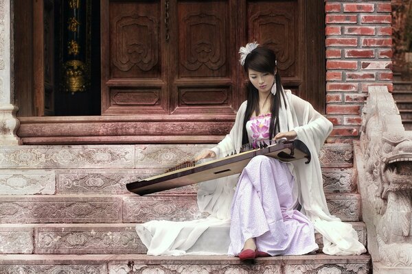 A beautiful girl plays the harp