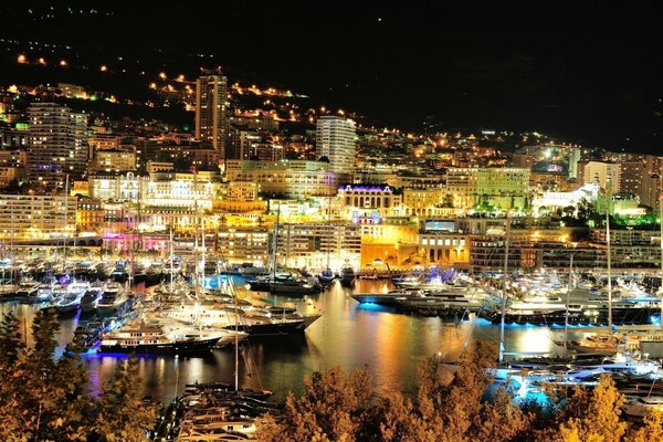 Yachts against the lights of Monte Carlo at night