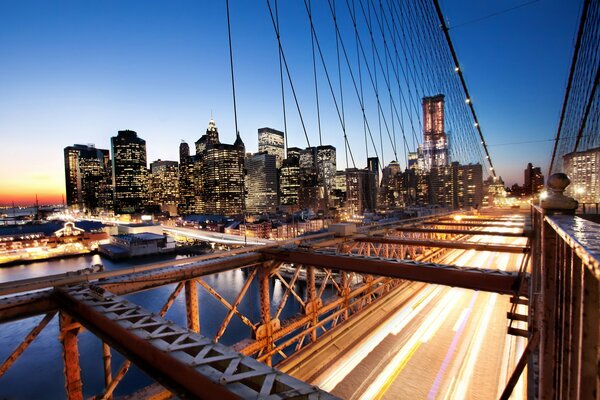 Bridge in the light of lanterns , houses and buildings in lights