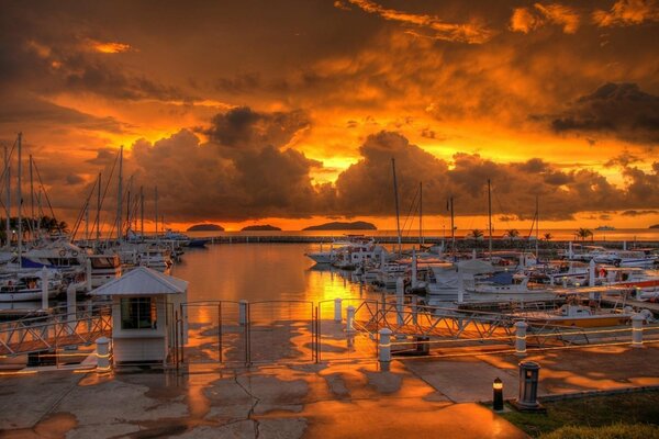 Pier on the background of sunset, sea and clouds