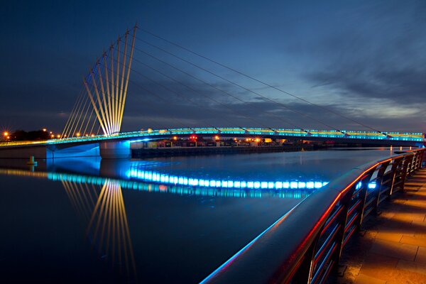 Evening city. The bridge at the embankment