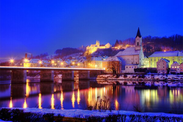 Evening city with lanterns near the river