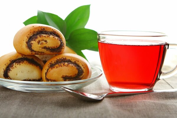 Buns with poppy seeds next to tea