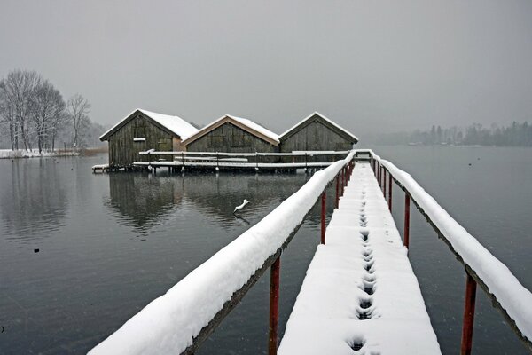 Snow bridge in the middle of the lake, shrouded in fog