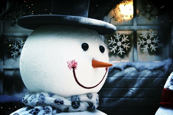 Christmas background with a snowman in a scarf and hat