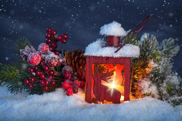 Lampe de poche de Noël avec un cerf et une branche d épinette sur la neige