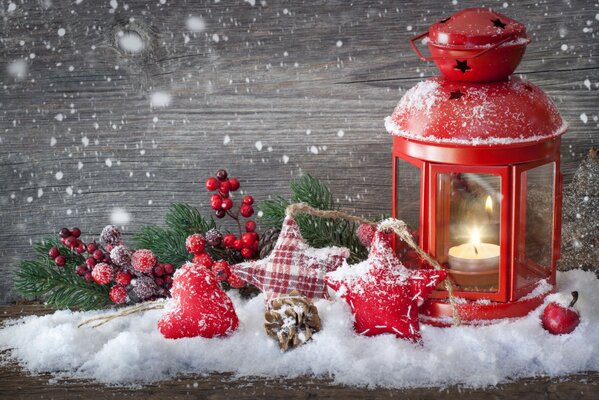 Christmas tinsel and a lantern in the snow