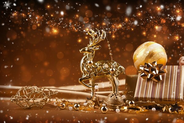 Christmas decorations. Golden deer next to a New Year s gift