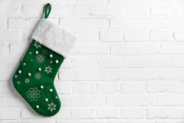 Green Christmas stocking hanging on the wall