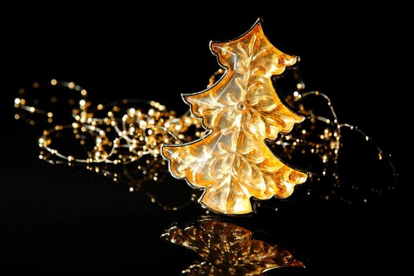 A golden Christmas tree on a black background