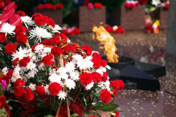 Eternal flame with a basket of flowers in the foreground