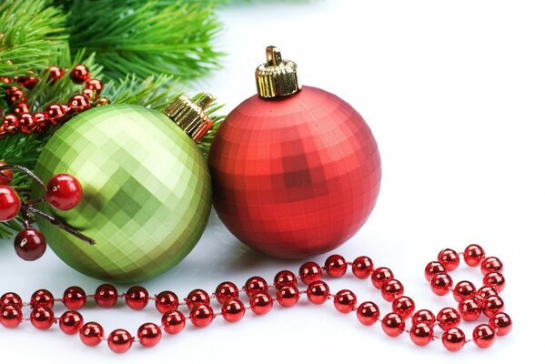 Christmas balls next to red beads