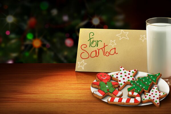 Christmas cookies on a white plate, a glass of milk and a note for Santa on a wooden table against the background of a festive Christmas tree