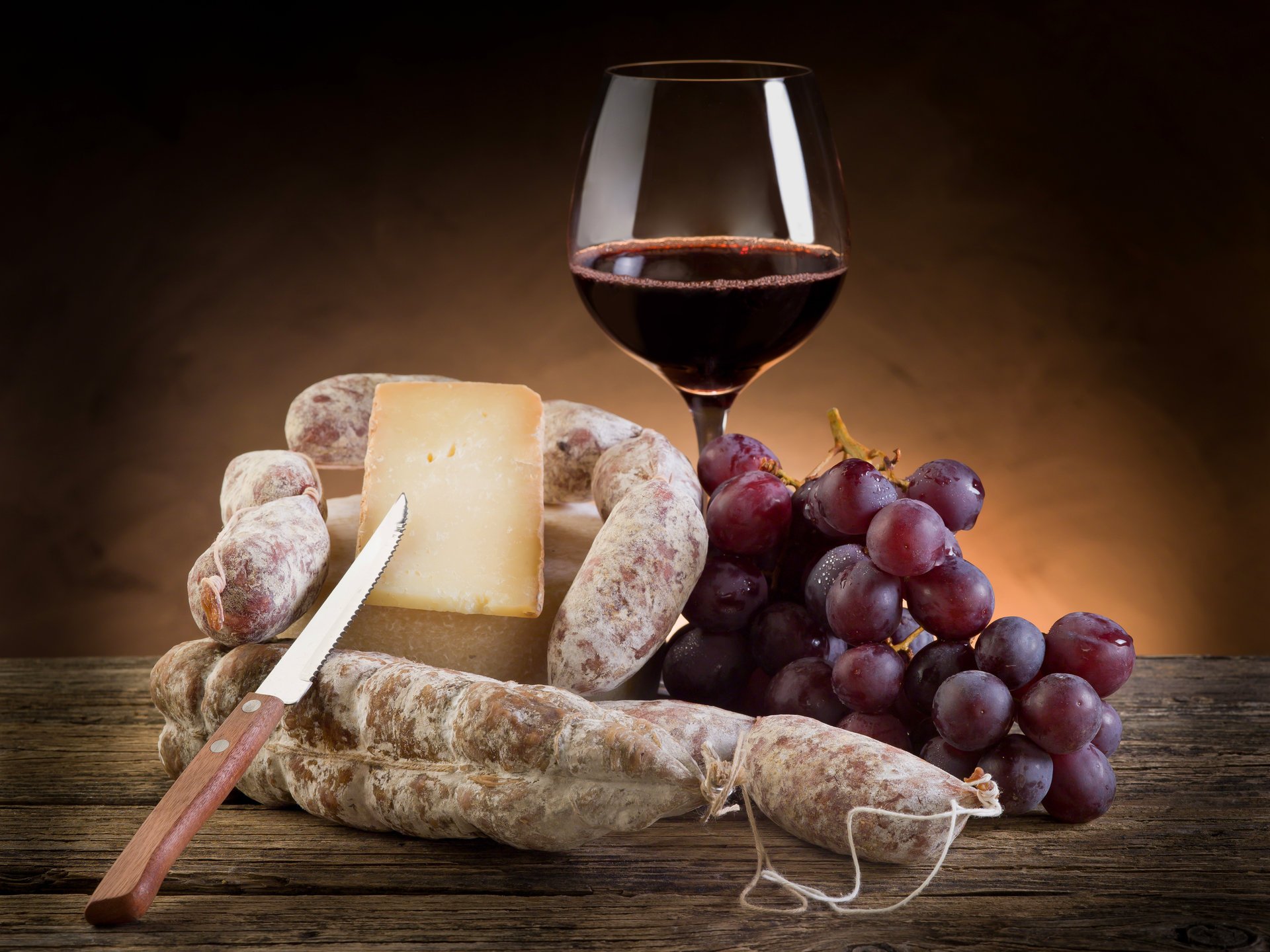 hunk glass bunch knife red wine cheese grape