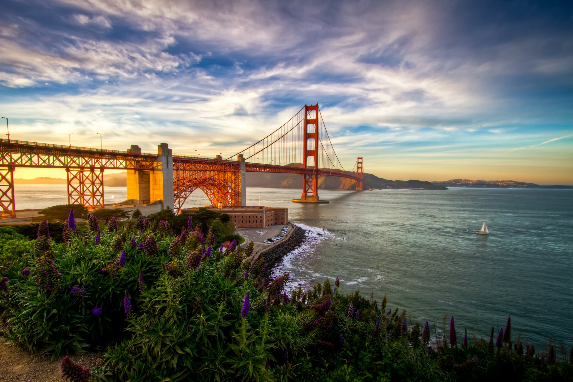 paysage nature pont mer ciel nuages montagnes fleurs herbe coucher de soleil vagues bateau