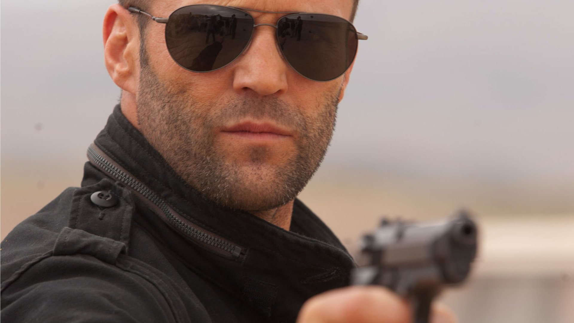 gun jason statham actor glasses male