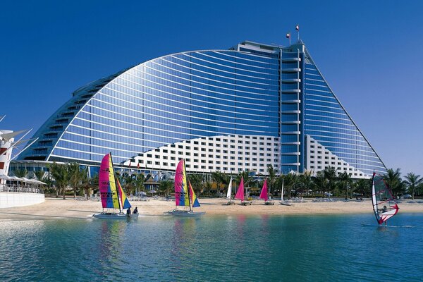 Surfers on the beach coast of a designer building