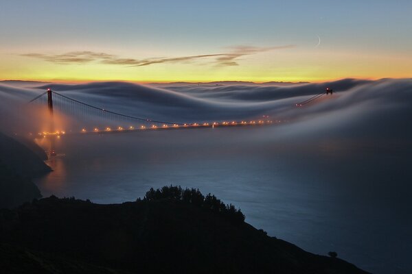 Foggy landscape with a bridge over the river