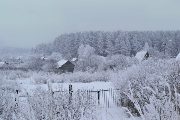 Winter landscape with a forest and a crowbar on the edge