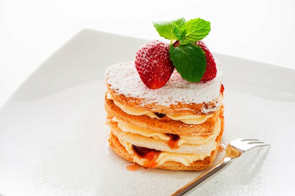 Dessert. Cake with cream, strawberries and mint