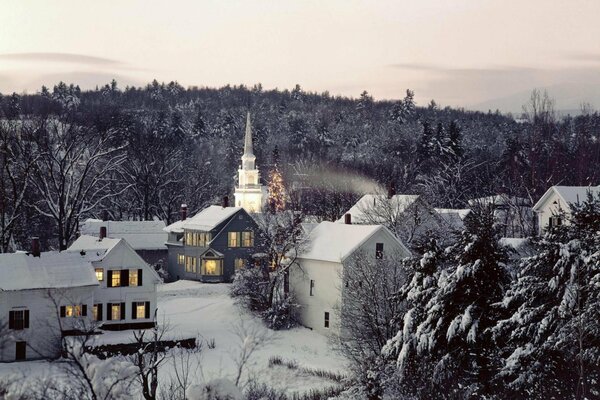 Winter evening landscape with houses and church