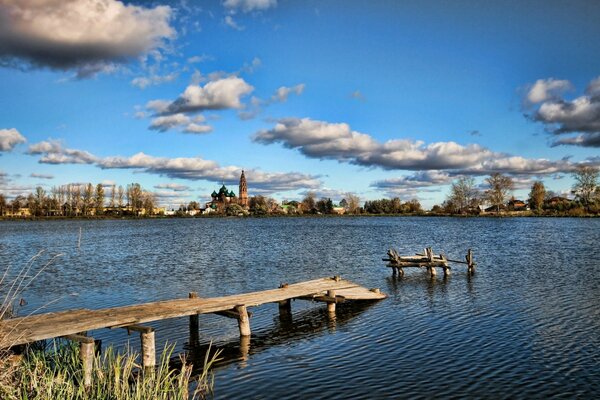 Panorama of the lake with a dilapidated pier