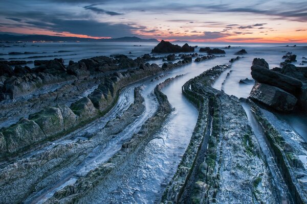 Sunset on the rocky sea coast