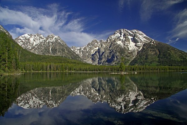 Montagnes enneigées se reflètent dans le lac