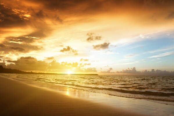 Paisaje con puesta de sol, mar y playa de arena