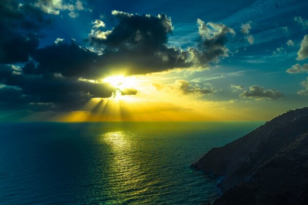 Sunset on the sea among mountains and rocks