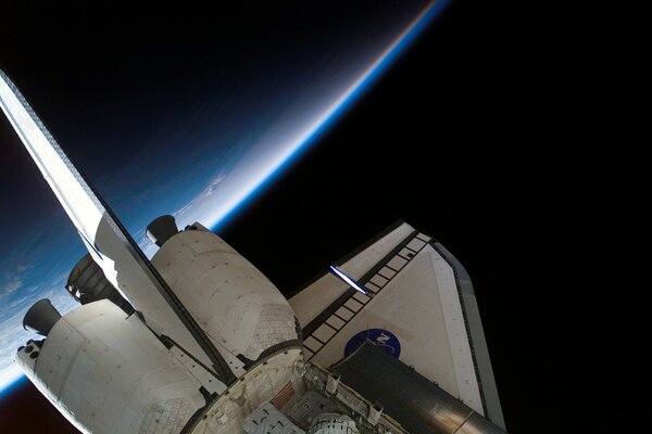 Shuttle in space against the background of the earth