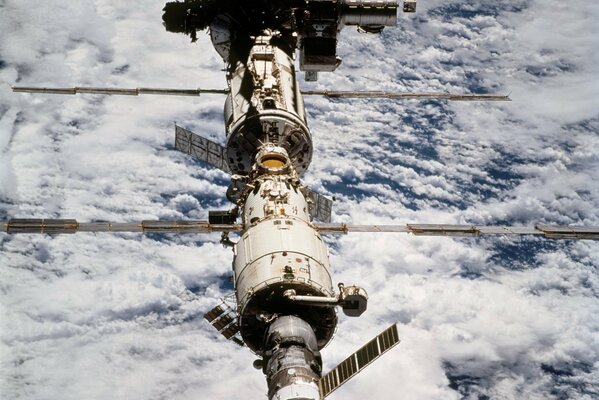 Iss on the background of the cloudy Earth