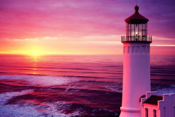 Lighthouse at sea at sunset