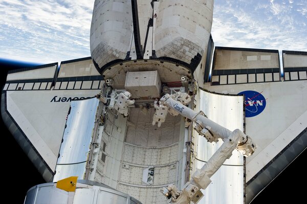 Shuttle discovery in space against the background of the earth