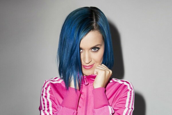 Singer Katy Perry in a pink tracksuit with bright blue hair