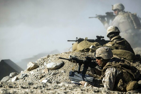 Soldiers in the trenches with weapons. Afghanistan