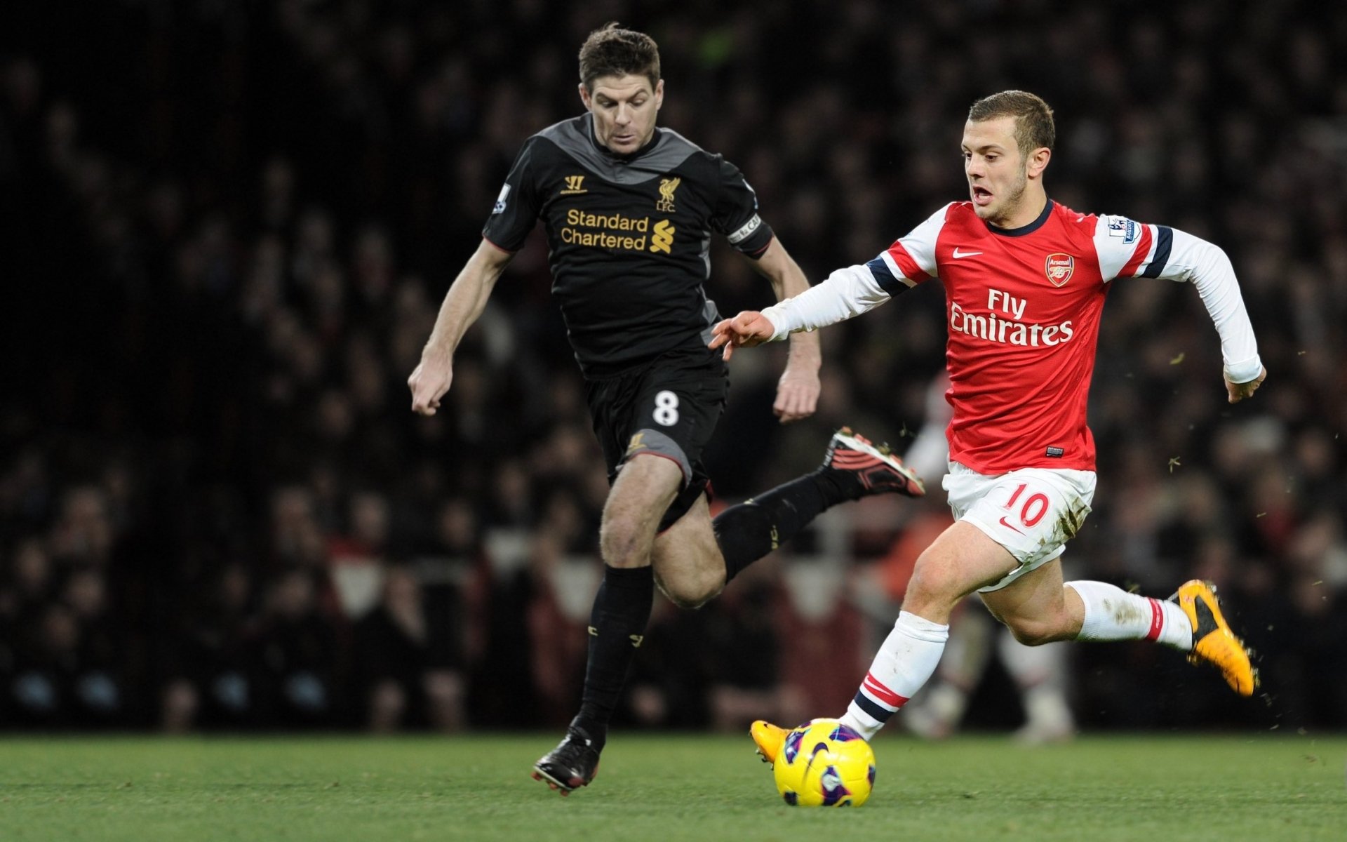 arsenal football club gunners jack wilshere midfielder field stands steven gerrard