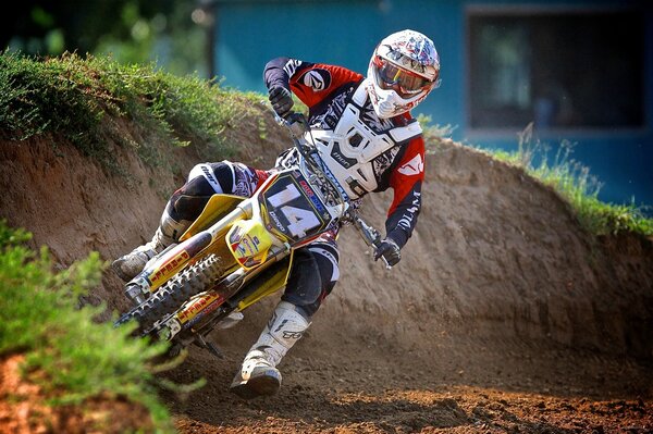 A man in motorcycle gear on a bike