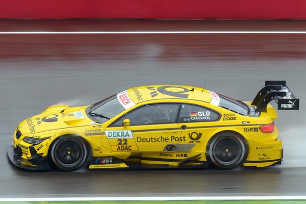 Yellow bmw m3 dtm in the race