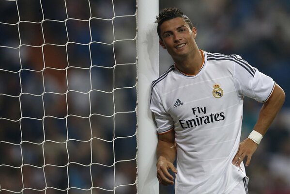 Cristiano Ronaldo smiles next to the goal