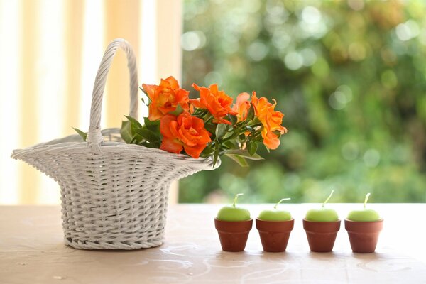 Beautiful roses in a basket. Candles on the table