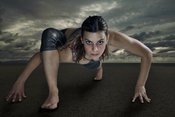 The girl is standing in a yoga pose