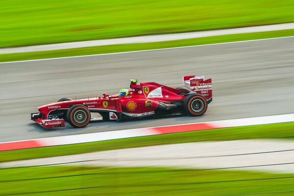 A racing car is racing along the track